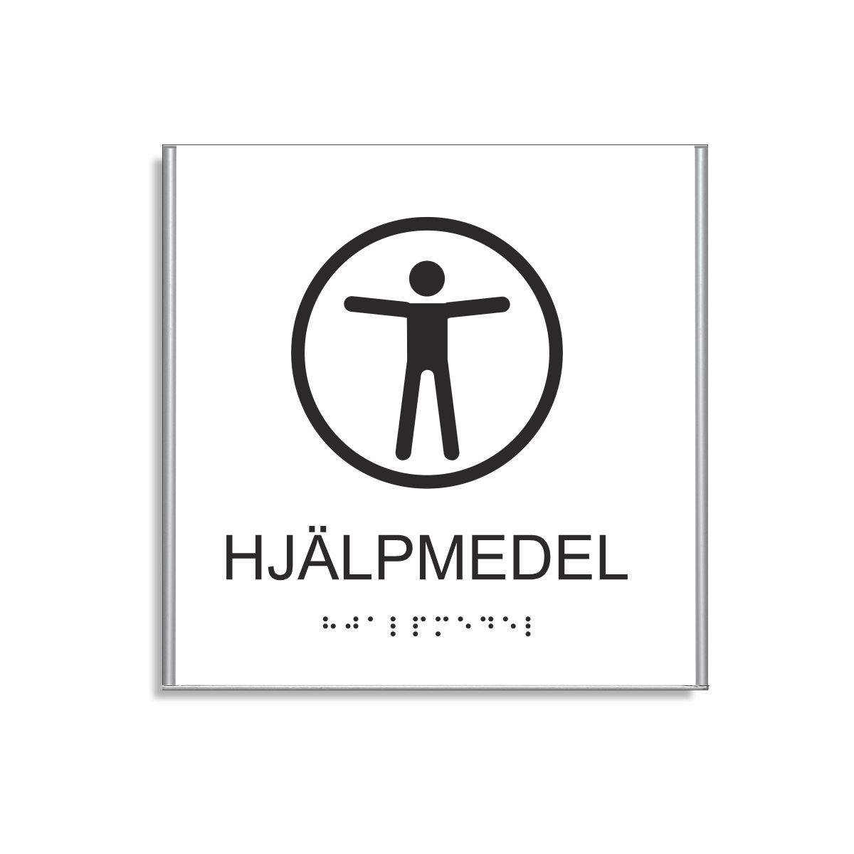 Vit och svart skylt för hjälpmedel i storlek 150 x 150 mm med en tunn aluminiumram, med piktogram av en människa med utsträckta armar inuti en cirkel, texten hjälpmedel står under symbolen och punktskrift längst ned