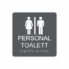 Charcoalgrå och vit skylt för personaltoalett med piktogram av en kvinna och en man åtskilda av ett lodrätt streck, texten personal toalett står under symbolen och punktskrift längst ned
