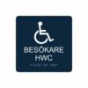 Mörkblå och vit toalettskylt för besökare hwc med piktogram av en rullstol, texten besökare hwc står under symbolen och punktskrift längst ned